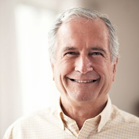 A man with grey hair smiling for the camera.